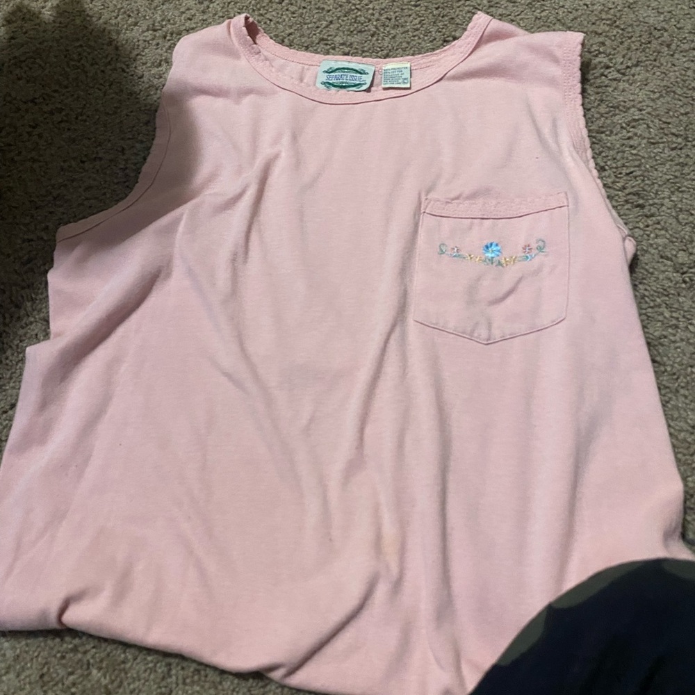 Light pink tank top with blue flower on pocket